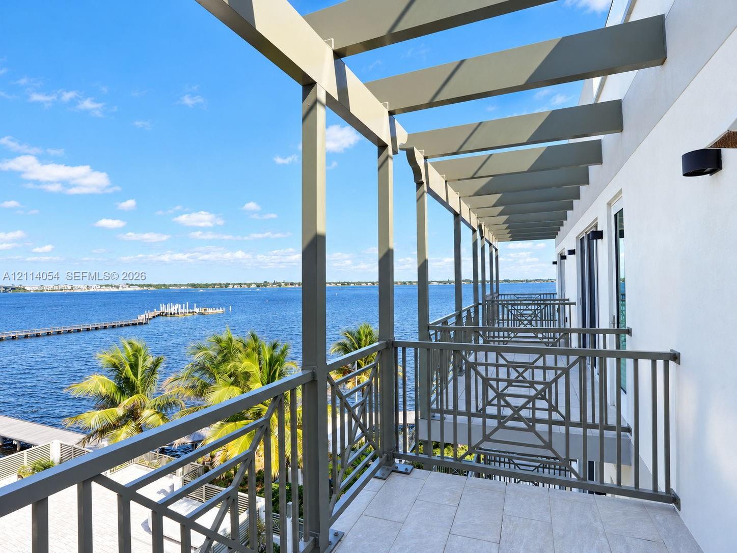 Covered balcony featuring a structural pergola, geometric metal railings, and tile flooring Covered balcony featuring a structural pergola, geometric metal railings, and tile flooring