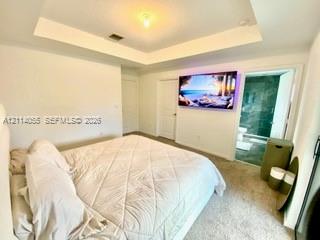 Tray ceiling, neutral carpeting, and solid-core interior doors
