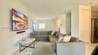 Open-concept interior featuring light-toned flooring, recessed lighting, and a neutral color palette