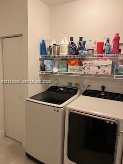Laundry area featuring dual-tier white wire shelving and a floor-to-ceiling bi-fold door closet