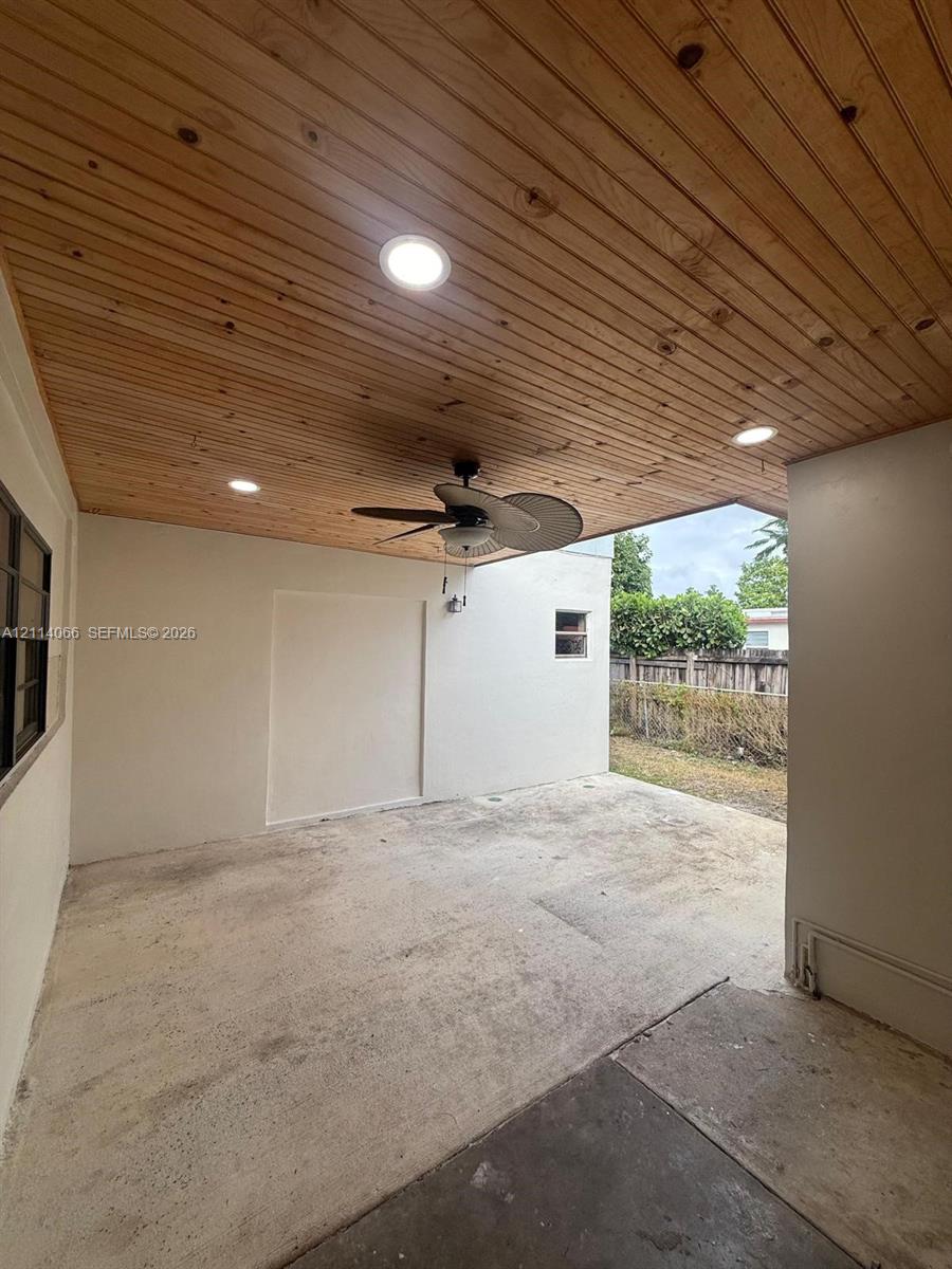 Covered patio featuring a natural wood-plank ceiling, recessed lighting, ceiling fan, and concrete flooring