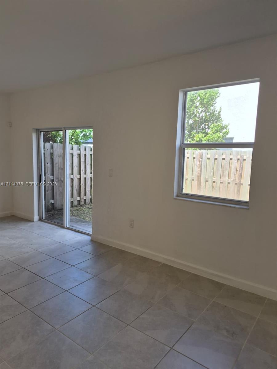 Ceramic tile flooring, sliding glass door, and a single-hung window