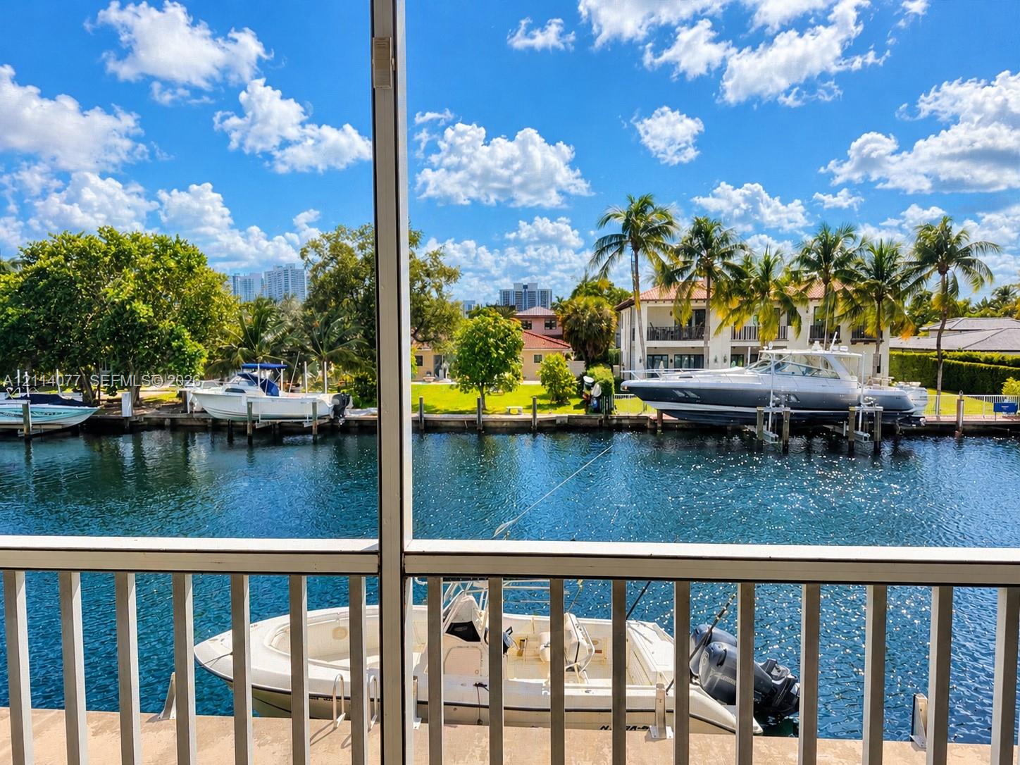 Screened enclosure featuring a concrete bulkhead, private boat slip, and direct waterway access