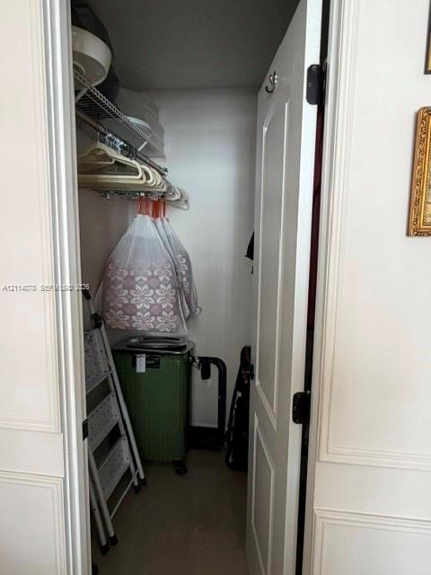 Storage closet featuring a single-panel interior door with brushed metal hardware and integrated wire shelving