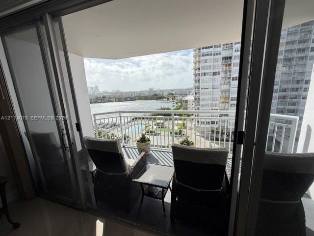 Private balcony featuring aluminum railing and sliding glass door entry
