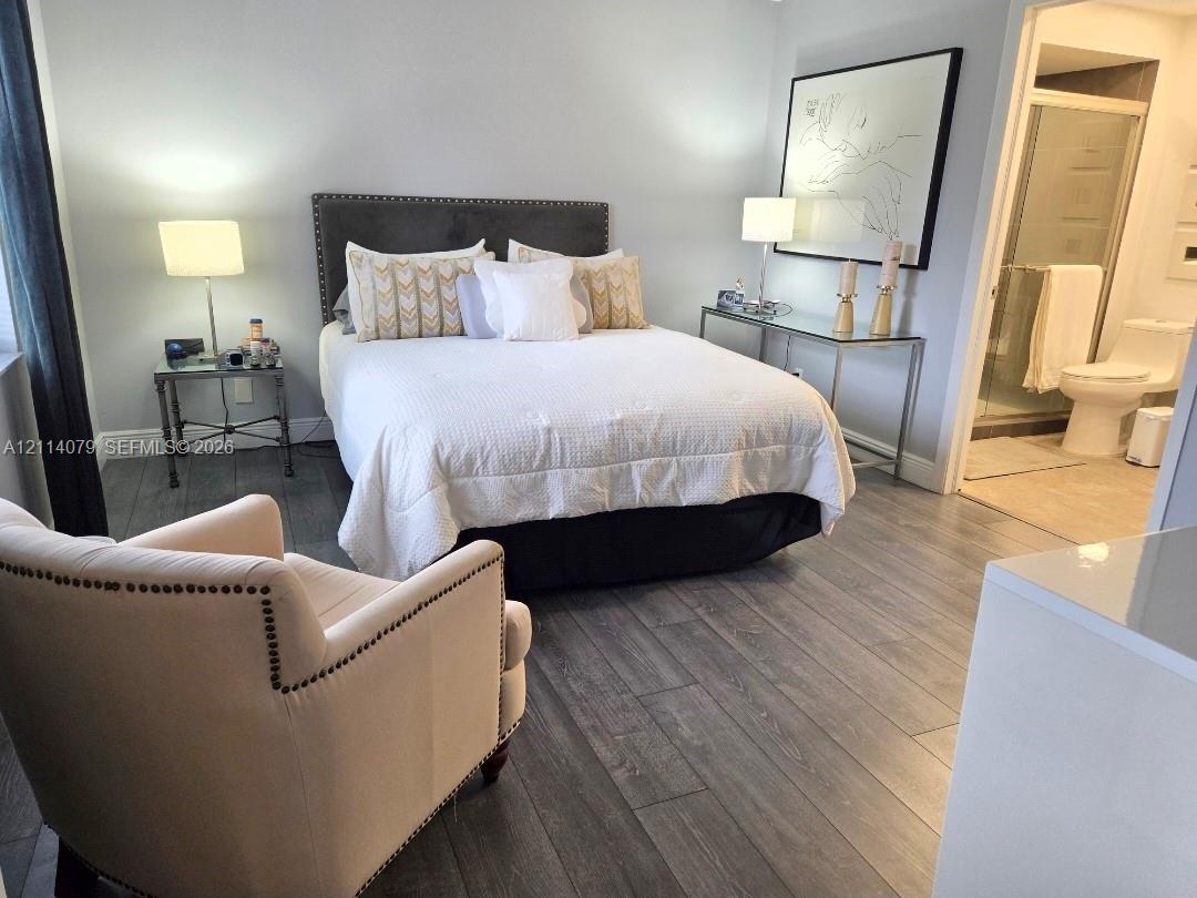 Wood-finish flooring, glass-enclosed shower, and neutral wall color palette Wood-finish flooring, glass-enclosed shower, and neutral wall color palette