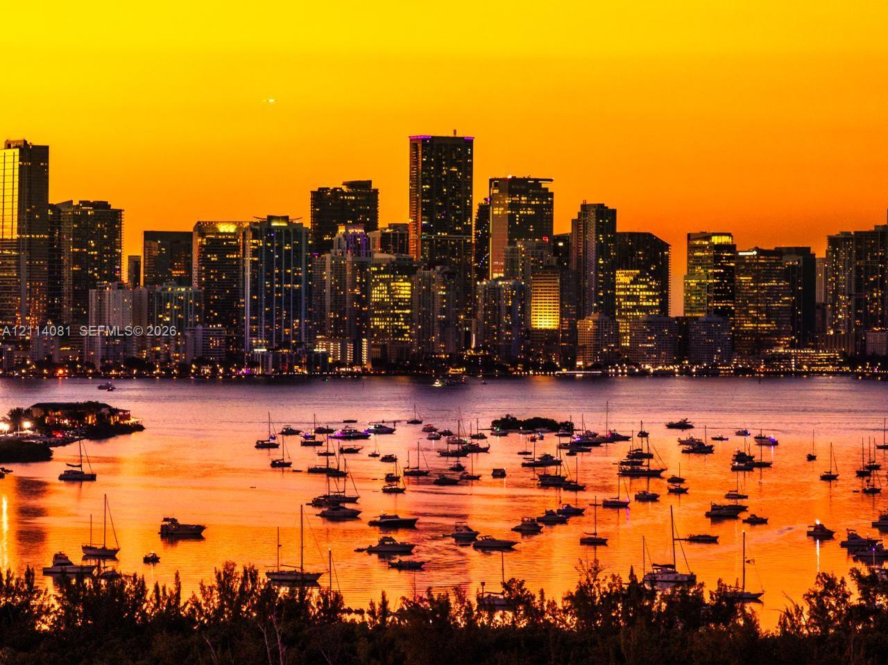 Panoramic skyline backdrop featuring a coastal waterway and anchored sailboats