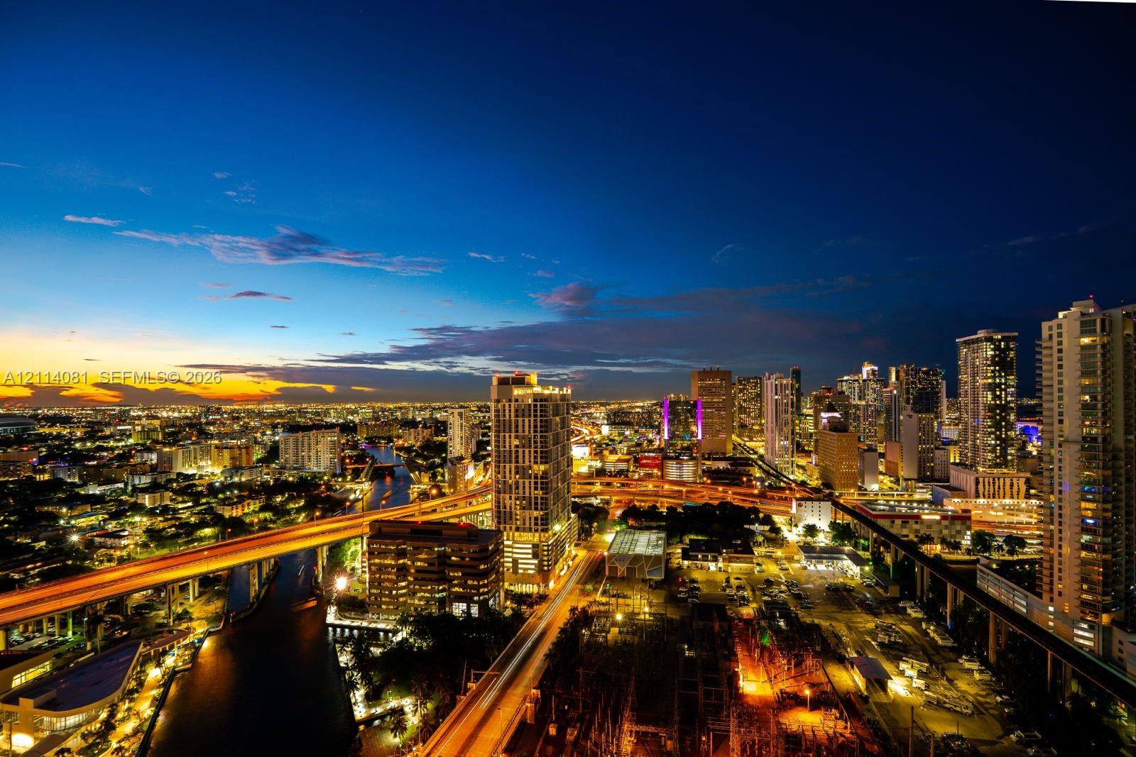 High-elevation urban skyline featuring extensive cityscape illumination and prominent metropolitan architecture