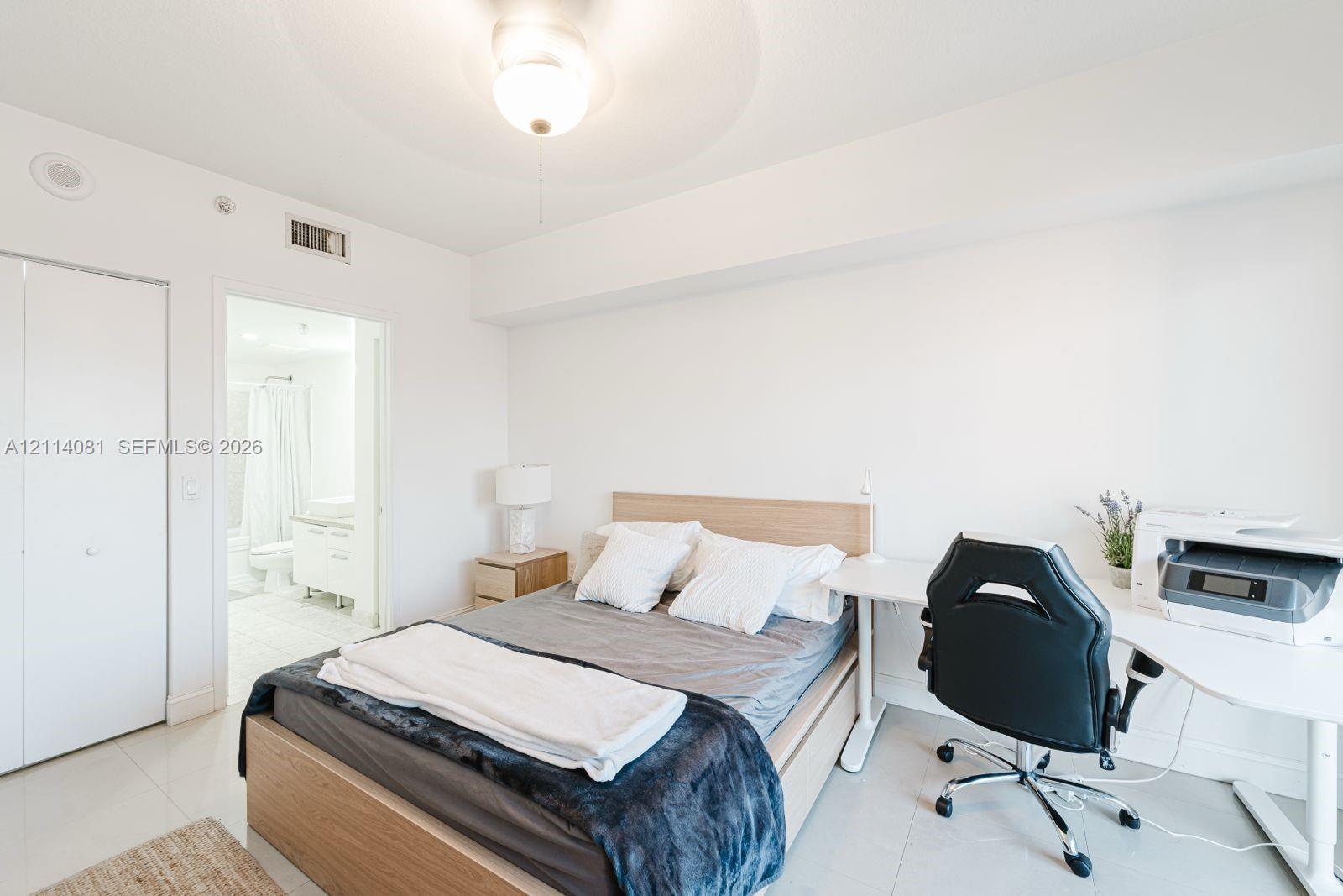 Neutral wall tones, polished tile flooring, and a flush-mount ceiling light fixture