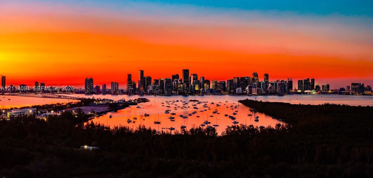 Panoramic city skyline horizon, expansive waterfront, and vibrant sunset backdrop
