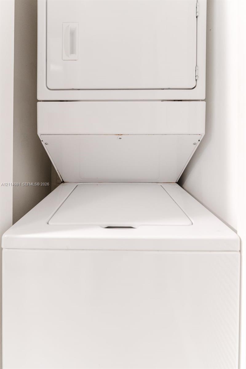 Stacked white top-load washer and dryer unit