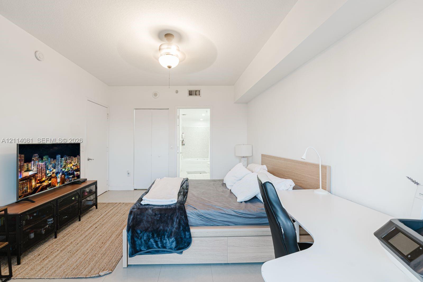 Neutral-toned interior featuring smooth-finish ceilings, recessed lighting, and a ceiling fan with integrated light fixture