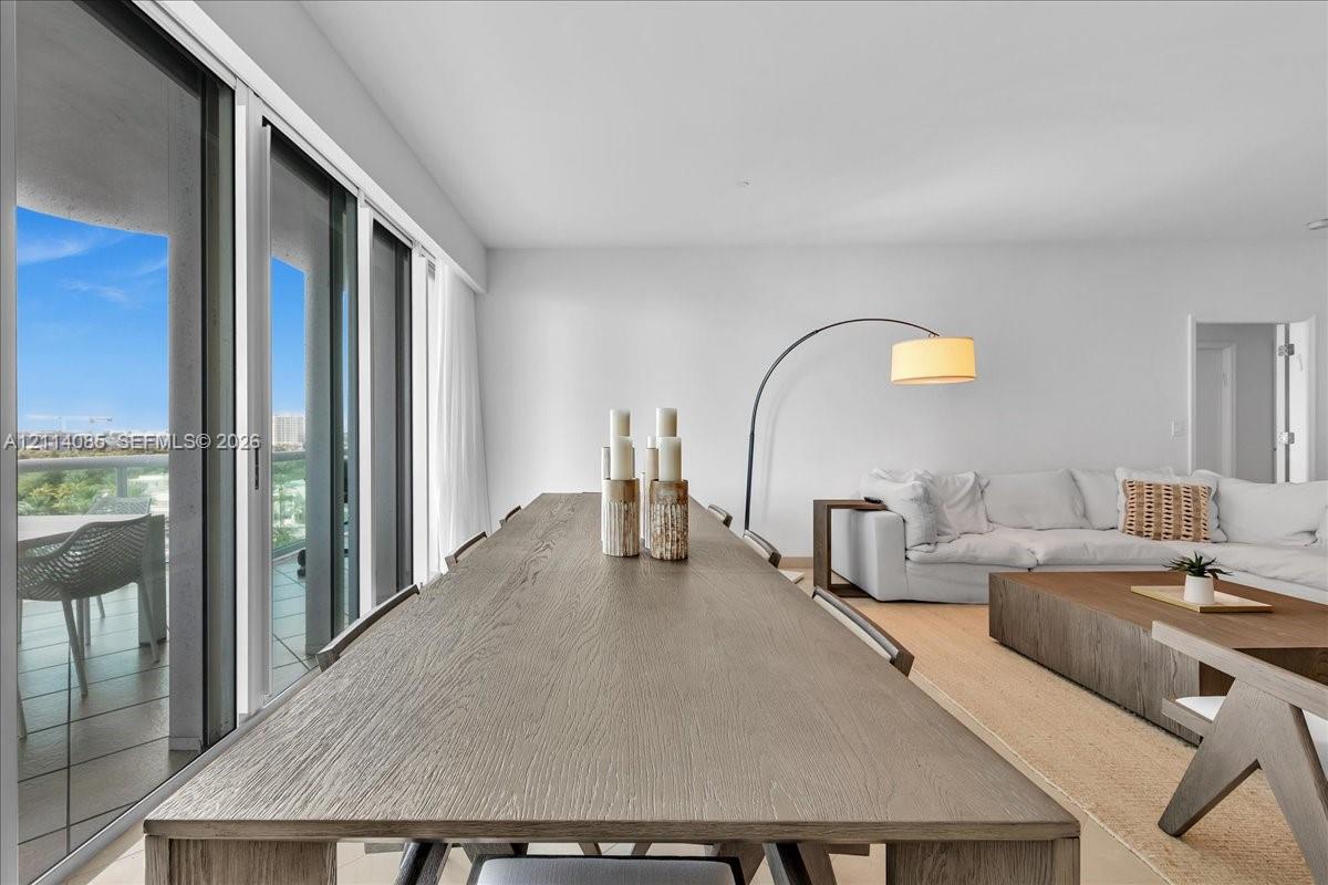 Floor-to-ceiling sliding glass doors, neutral interior walls, and wood-finish flooring