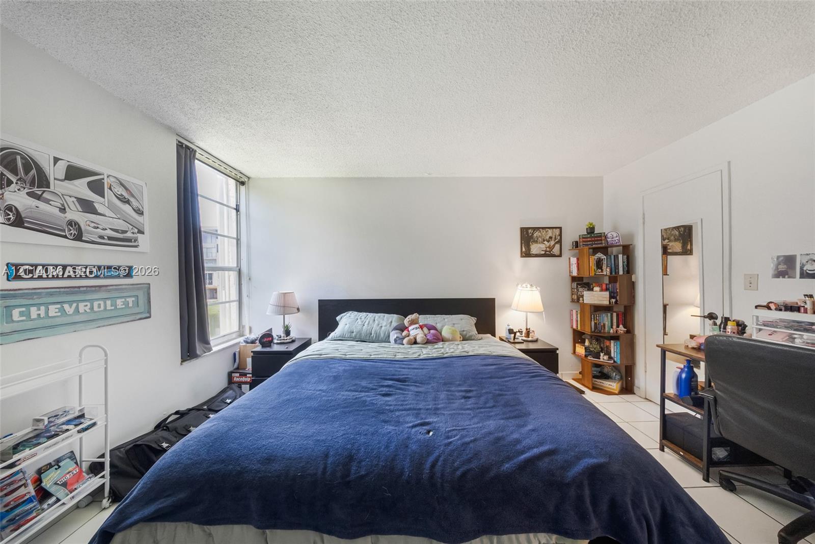 Room featuring tile flooring and a vertical sliding window