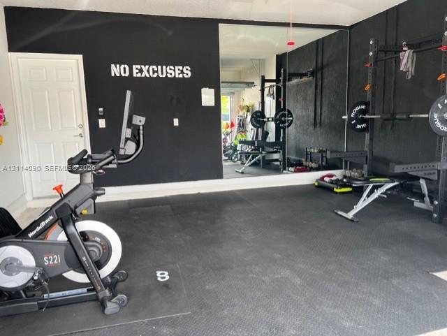 Finished garage space with wall-to-wall mirror and protective rubber flooring Finished garage space with wall-to-wall mirror and protective rubber flooring