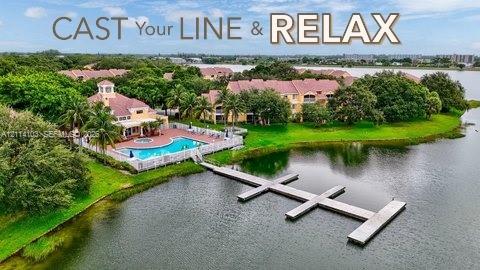 Waterfront community featuring a swimming pool, spa, and private multi-slip dock extending into the lake