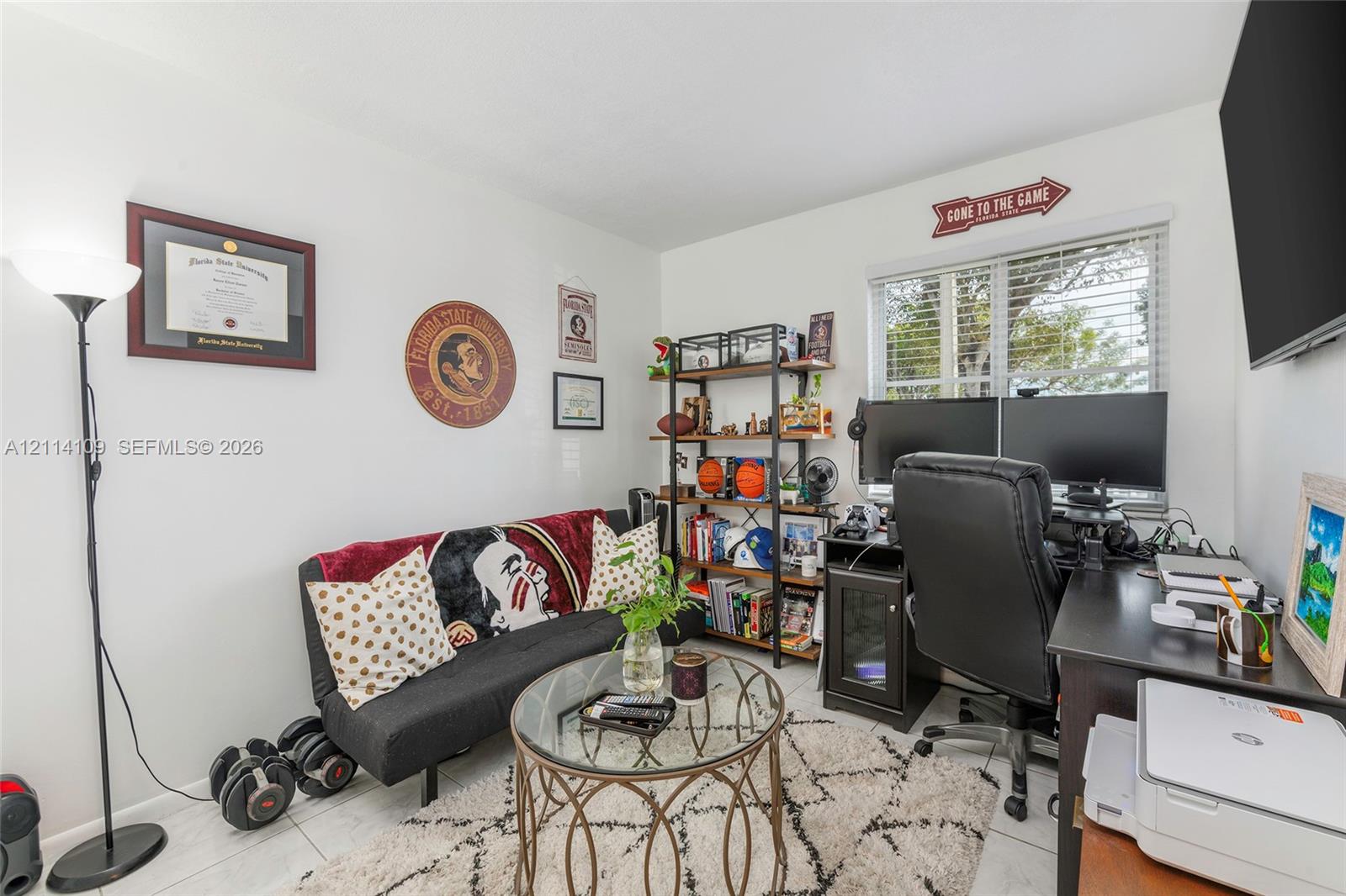 Room featuring white walls, white tile flooring, and a window with horizontal blinds