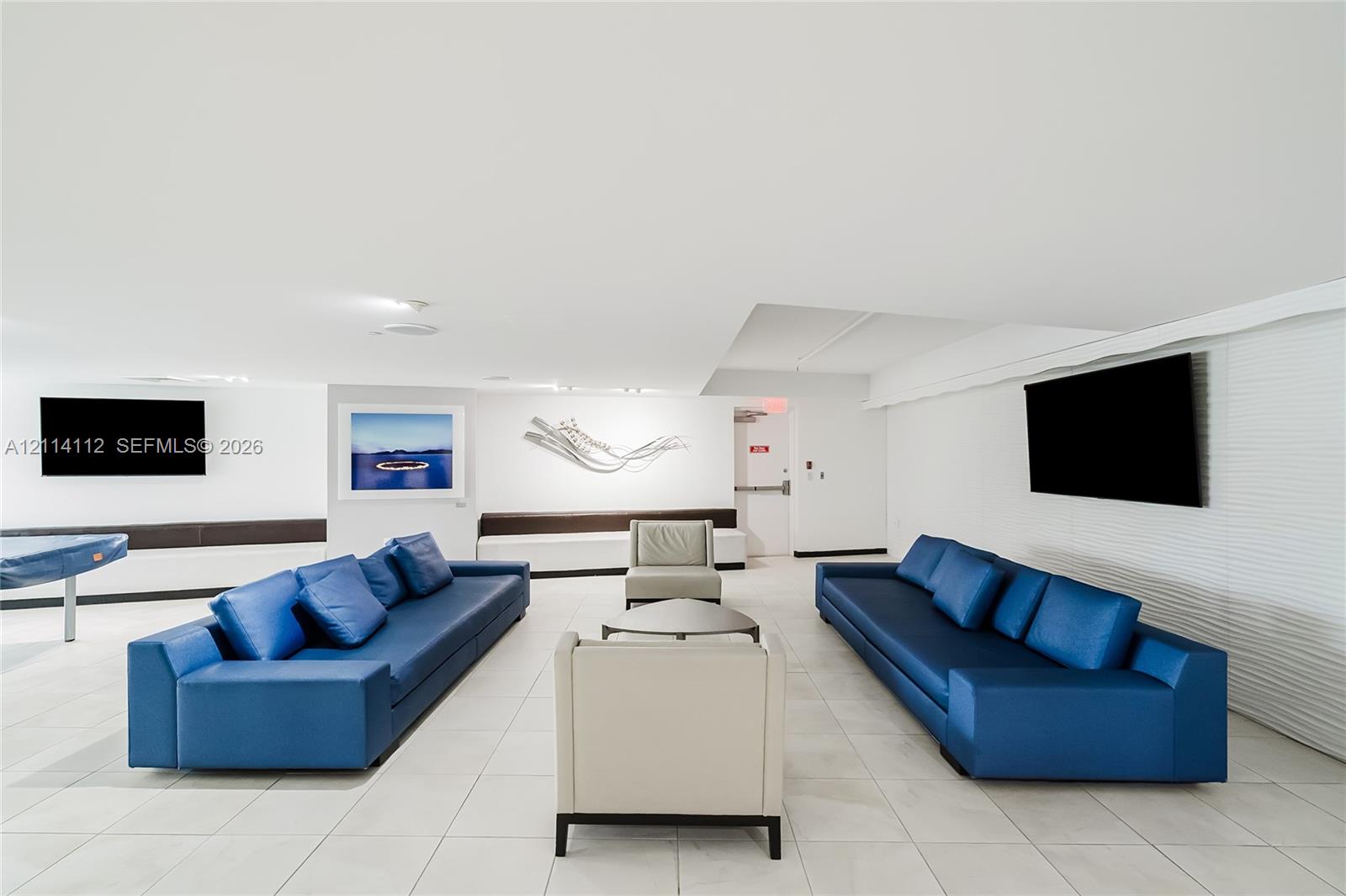Interior space featuring large-format tile flooring, recessed ceiling lighting, and horizontal textured wall paneling