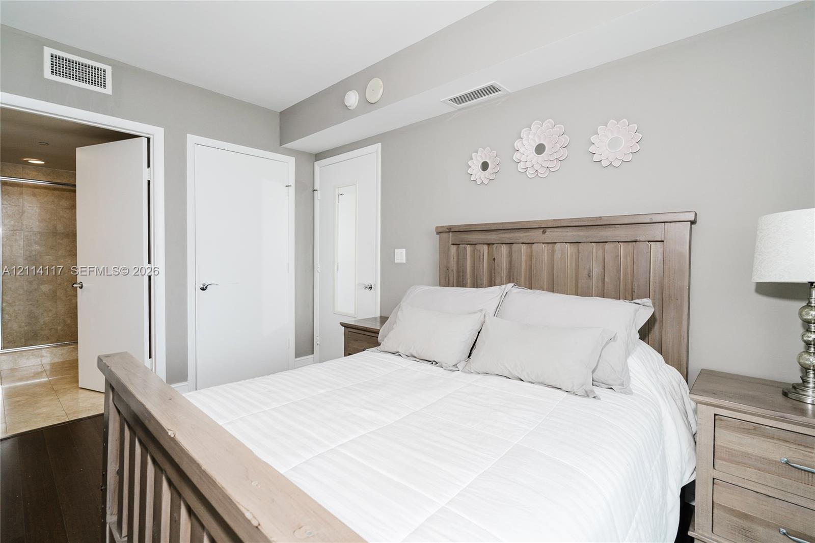 Neutral wall paint, wood-finish flooring, and solid-core interior doors