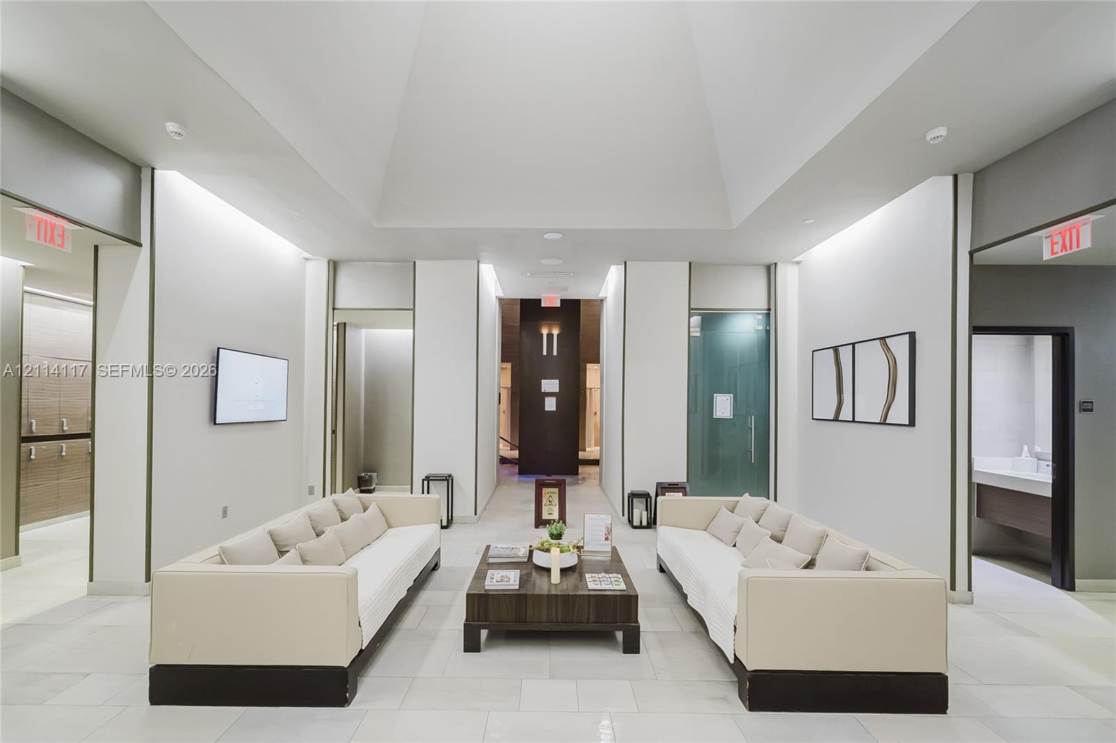 Vaulted ceiling, large-format tile flooring, recessed perimeter lighting, and neutral wall finishes