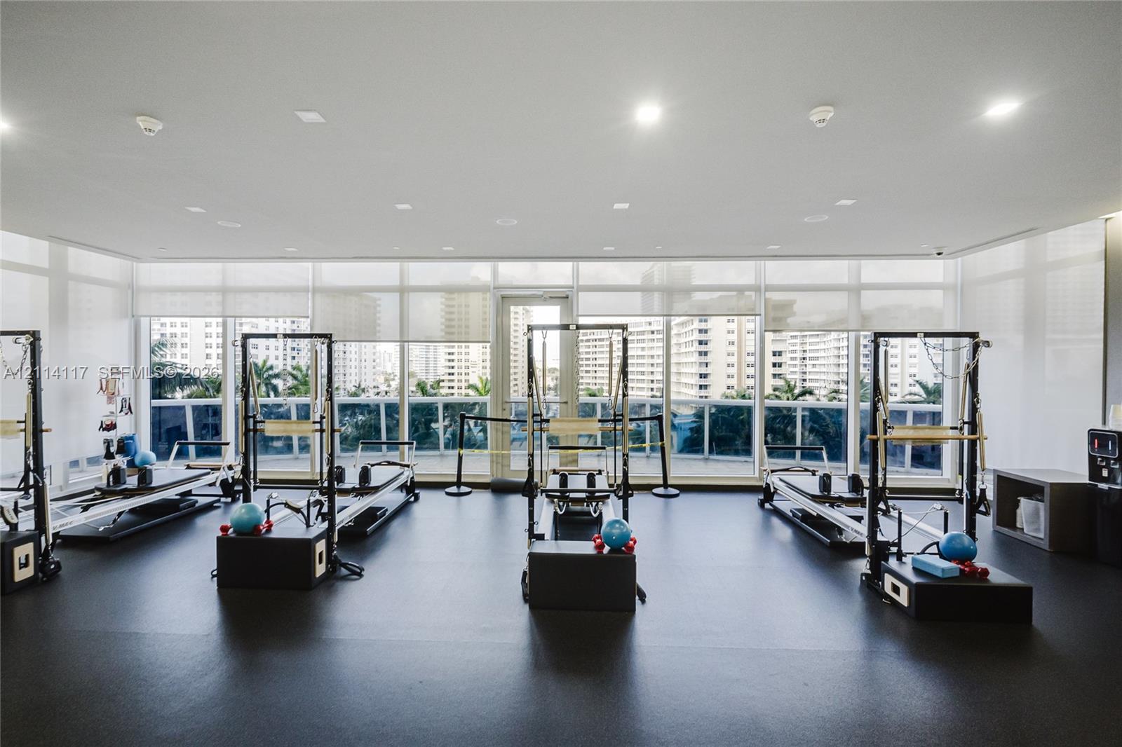 Fitness studio featuring floor-to-ceiling windows, recessed lighting, and resilient composite flooring
