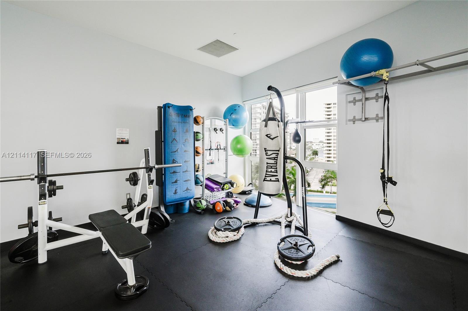 Fitness area featuring durable interlocking rubber flooring and floor-to-ceiling windows