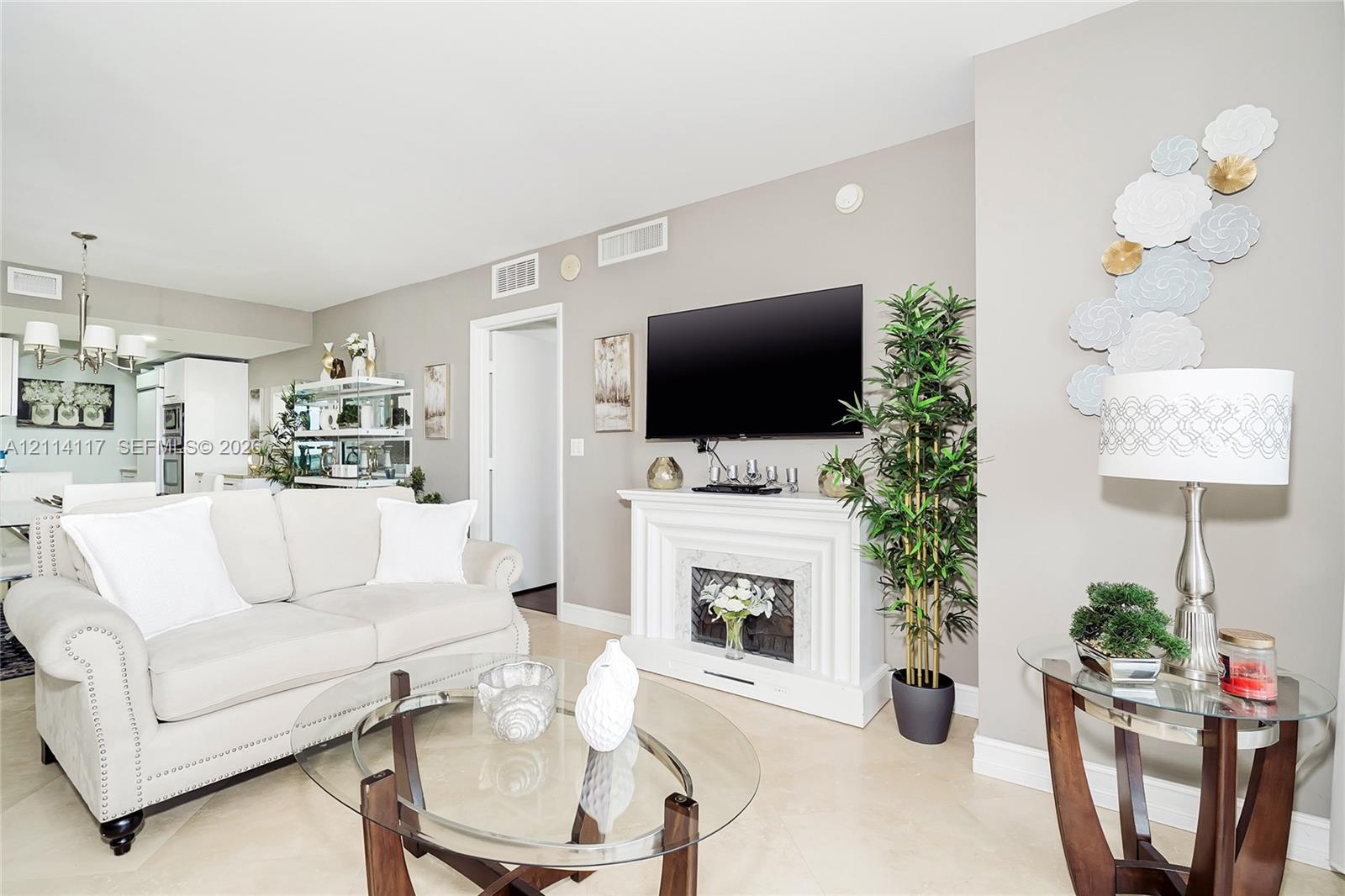 Living area featuring tile flooring, a white ornamental fireplace surround, and recessed ceiling lighting