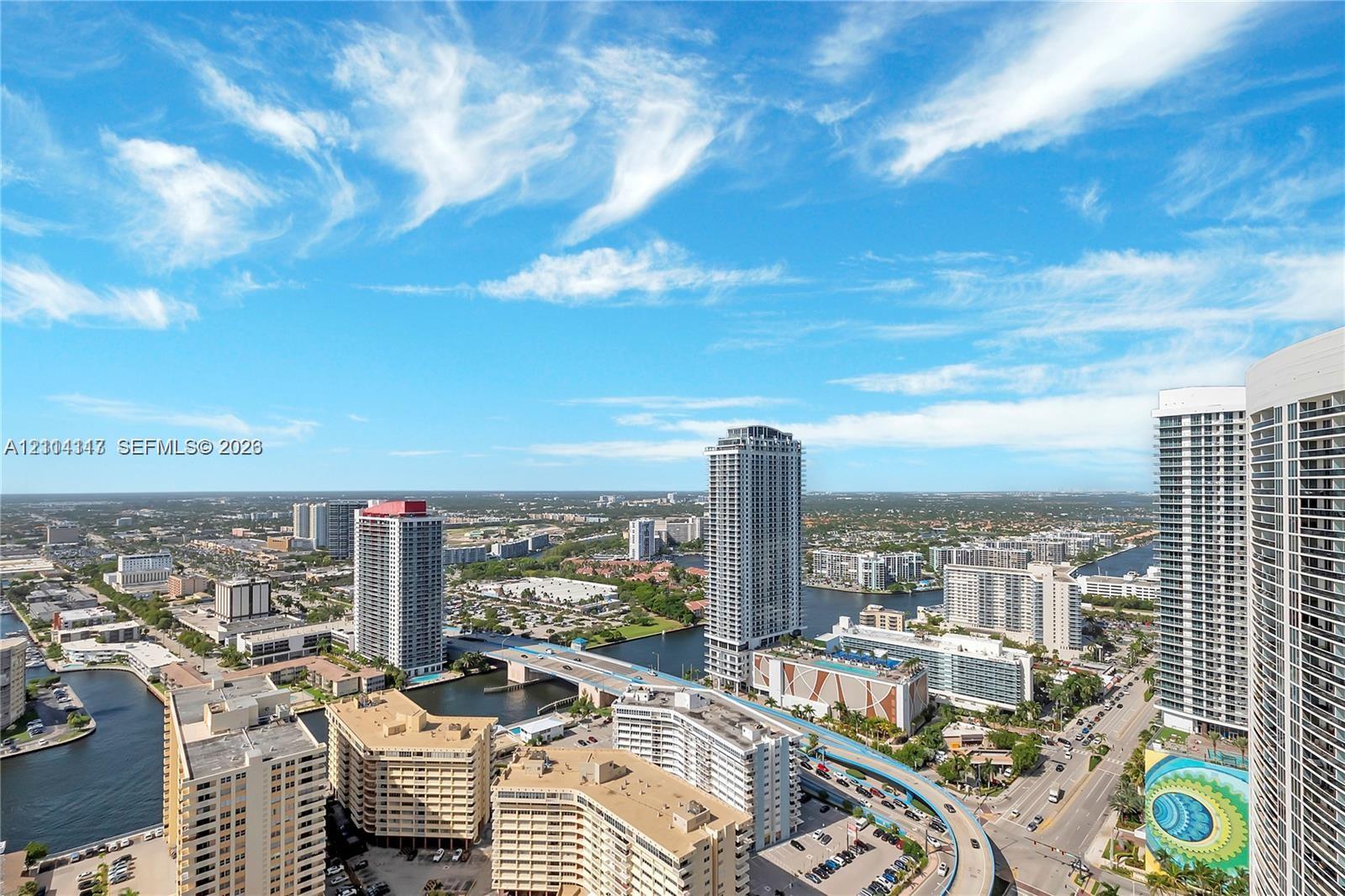 High-rise urban landscape featuring wide-angle panoramas of the surrounding cityscape, waterways, and bridges