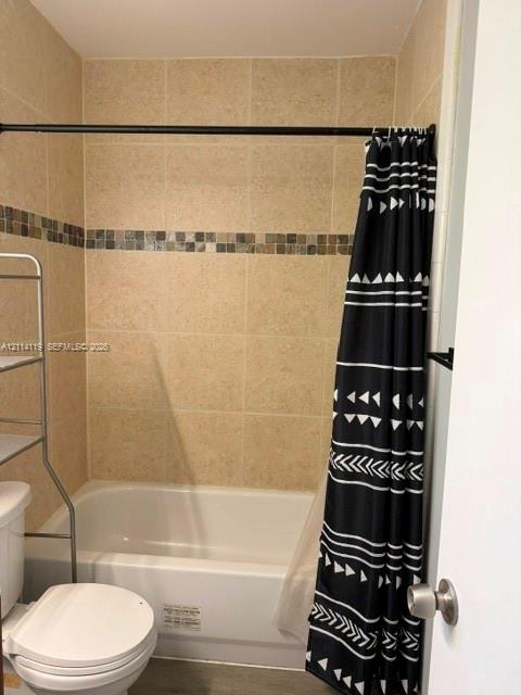 Bathtub with white surround and neutral wall tile featuring a decorative mosaic accent border