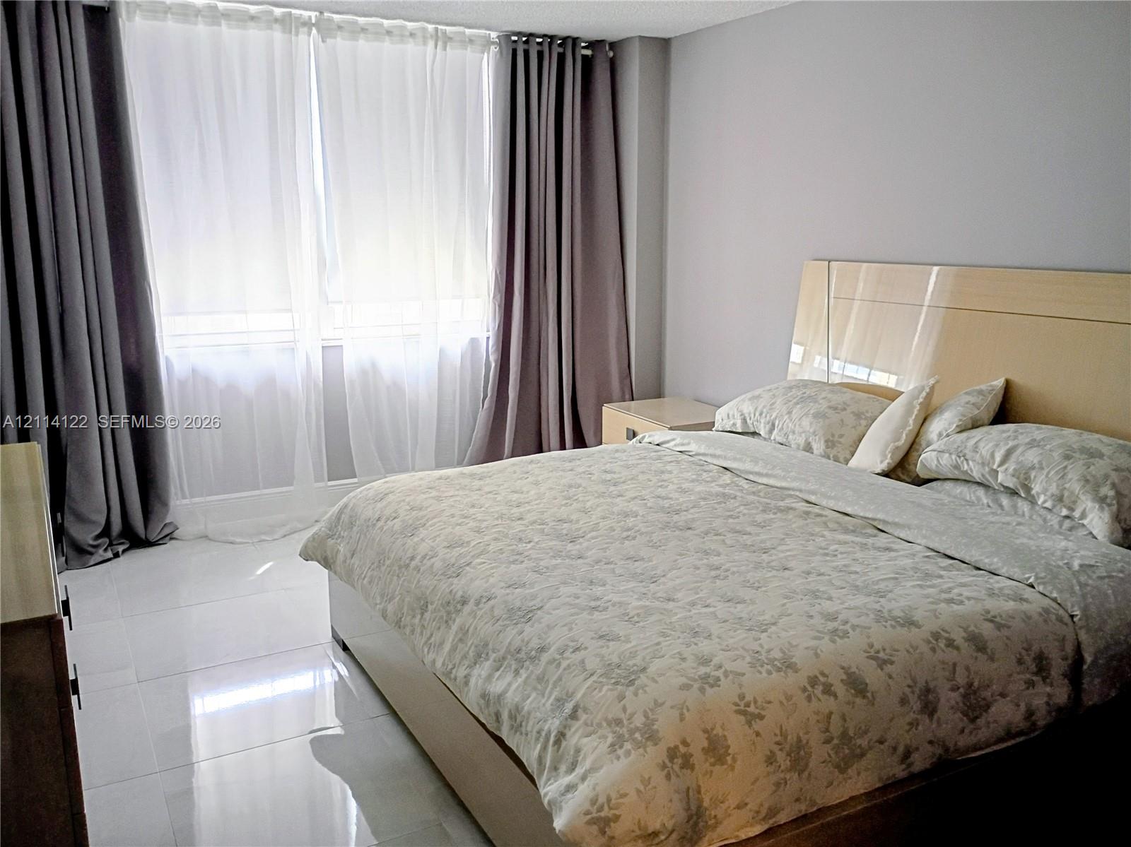 Large format tile flooring and floor-to-ceiling windows