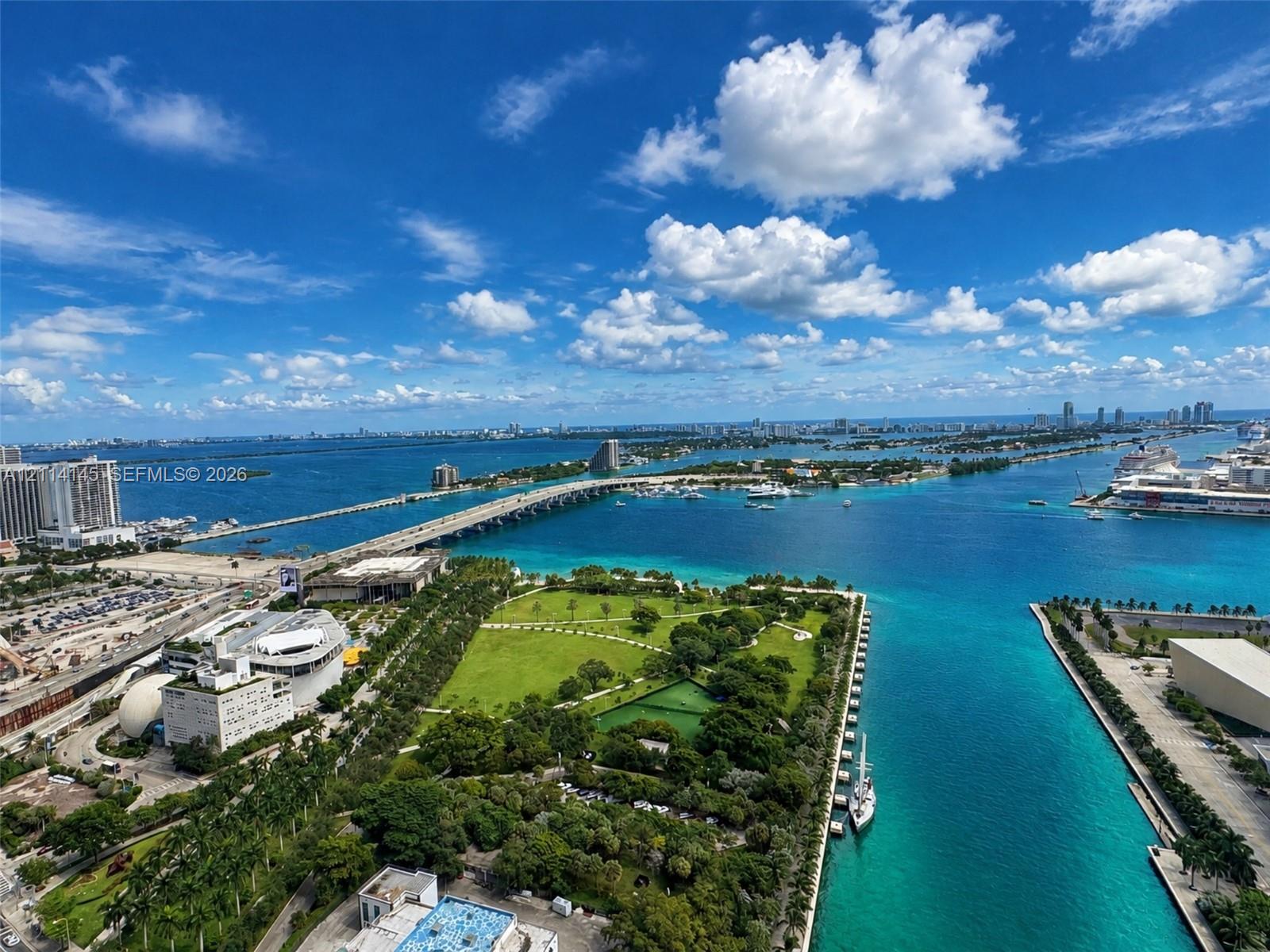 Elevated coastal outlook featuring turquoise water, expansive bay front, and bridge infrastructure