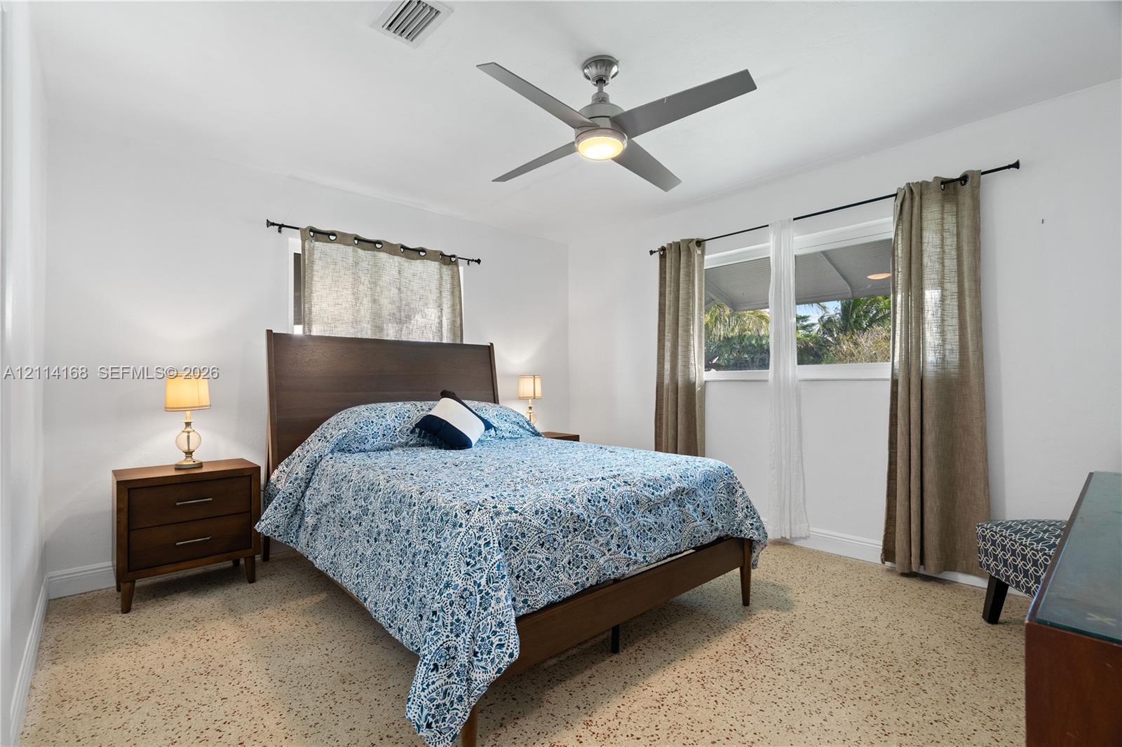 bedroom featuring Terrazo Tile, large windows with natural sunlight