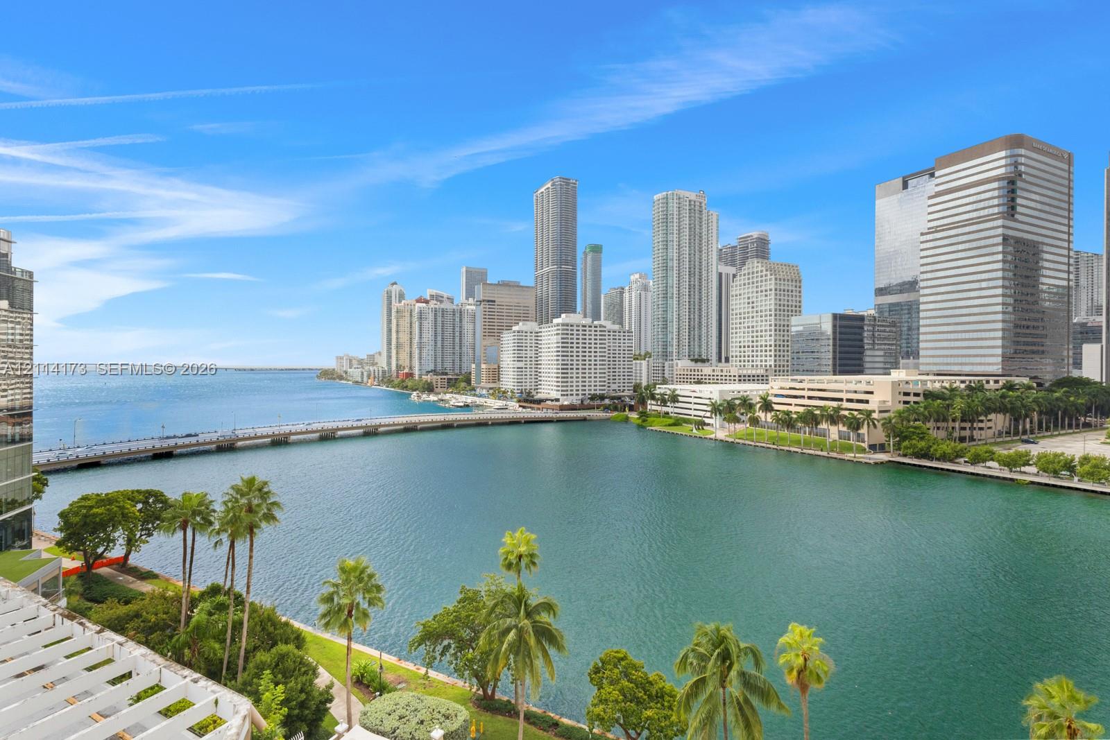 Panoramic waterfront outlook featuring the downtown skyline, a concrete bridge, and established palm trees Panoramic waterfront outlook featuring the downtown skyline, a concrete bridge, and established palm trees