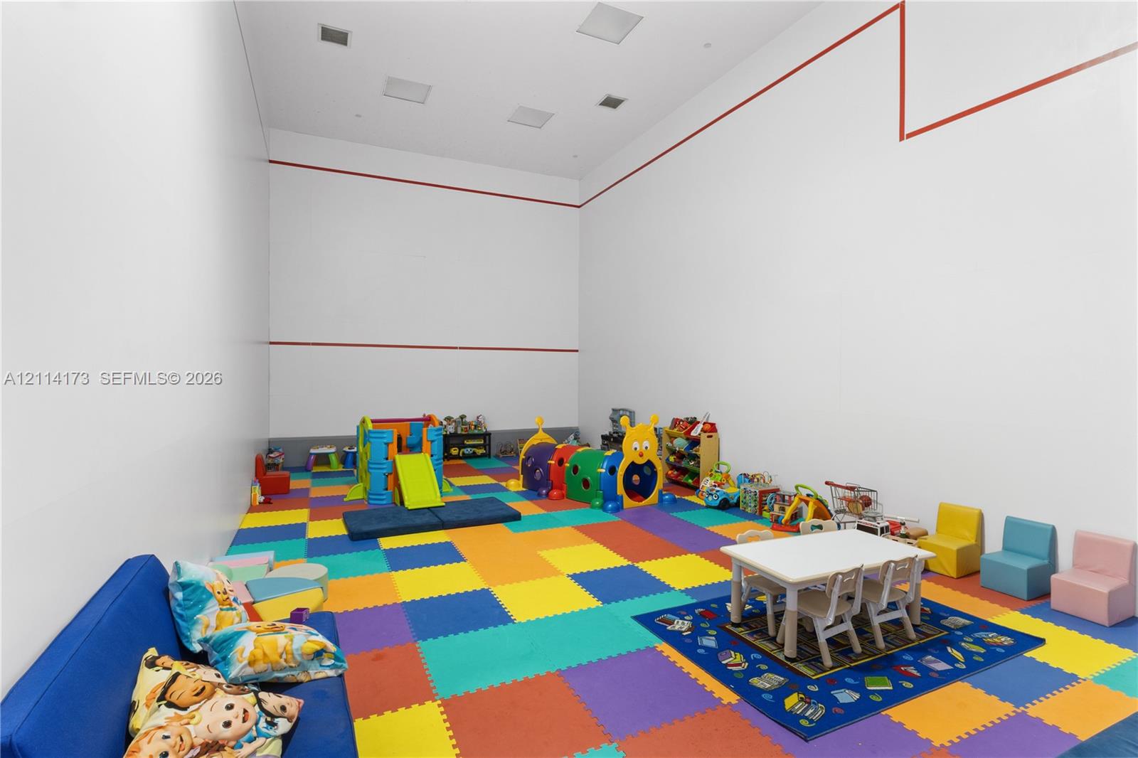 Indoor sports court featuring high ceilings, recessed lighting, and perimeter wall markings