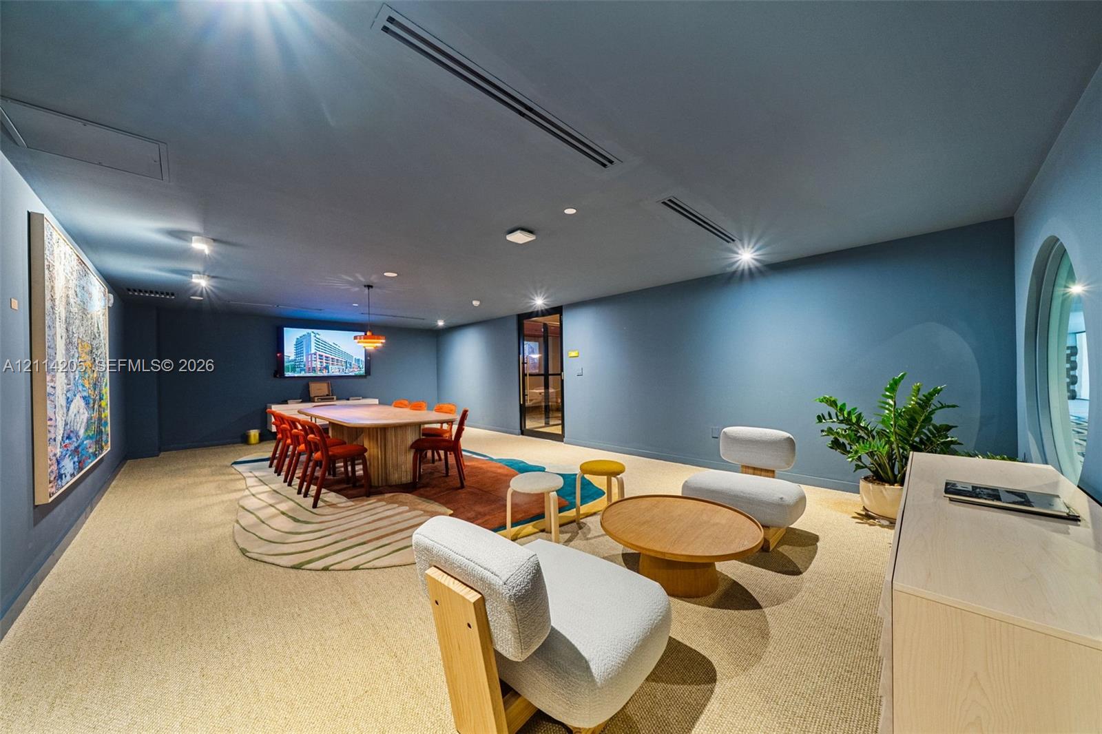 Conference rooom with spacious interior featuring integrated ceiling lighting, recessed air conditioning system, circular window, and neutral wall-to-wall carpeting