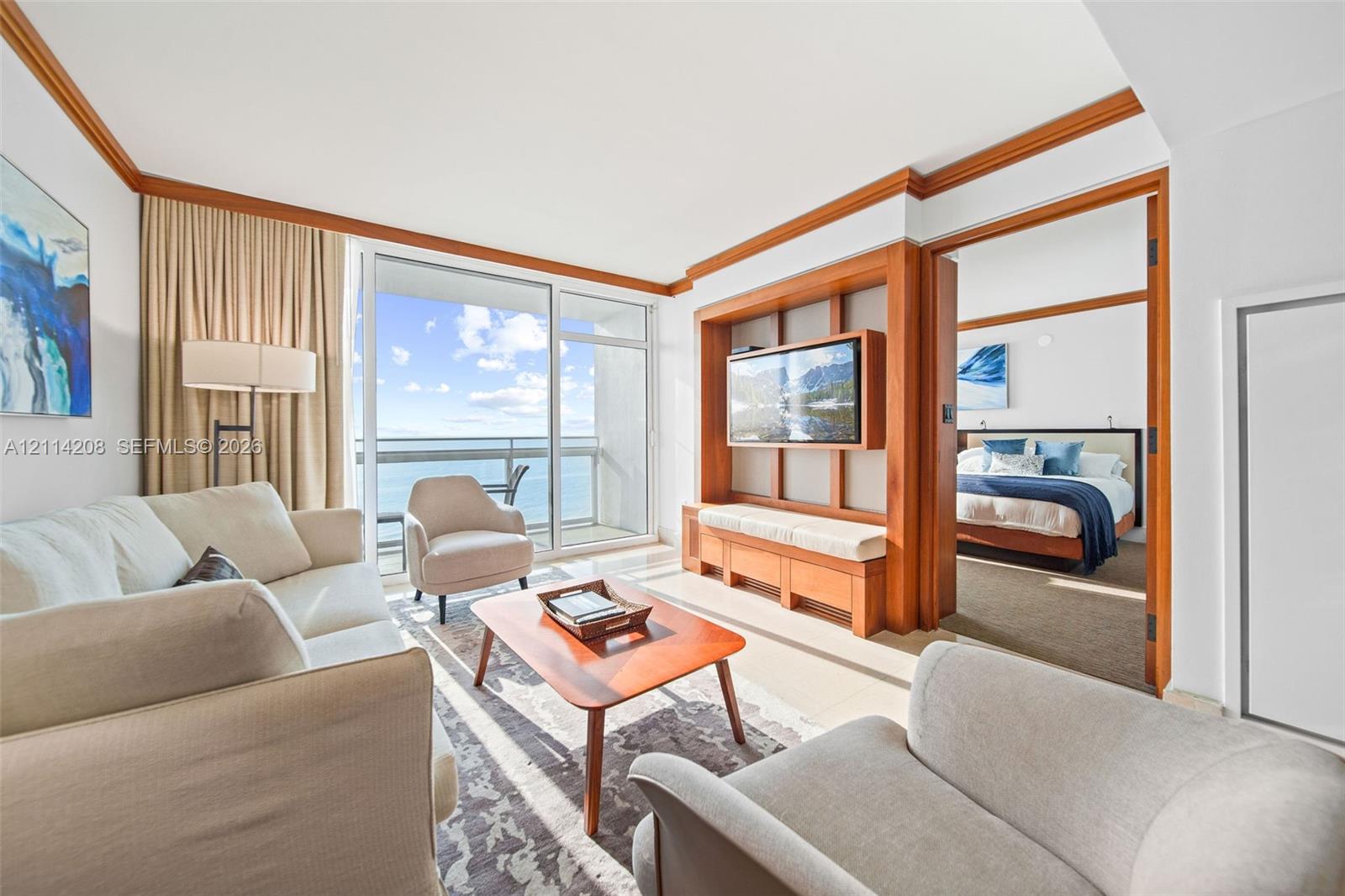 F a balcony, custom wood-trim media center with built-in cabinetry, and crown molding