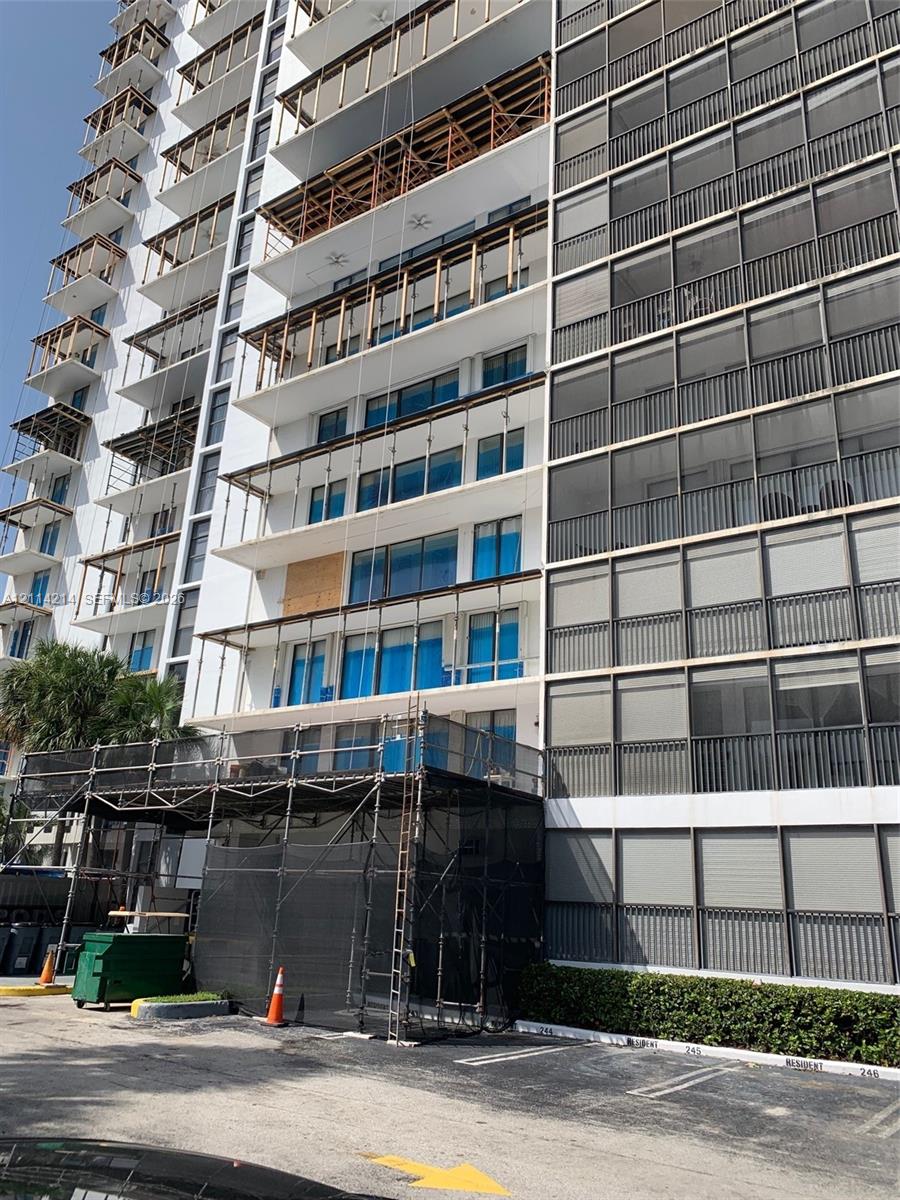 Multi-story residential high-rise featuring concrete facade construction, extensive private balcony space, and window systems