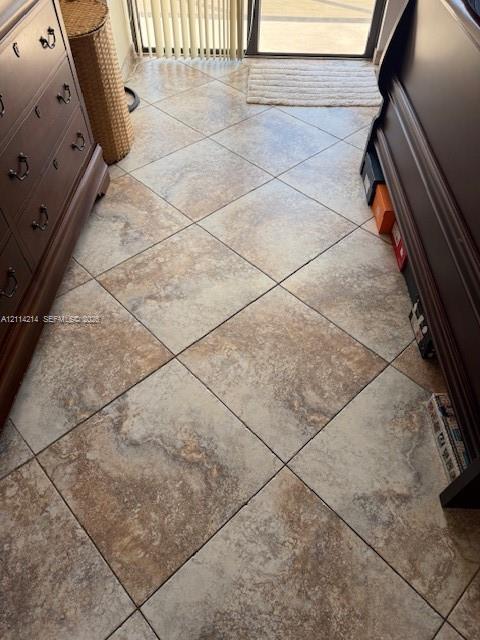 Large-format porcelain tile flooring with a neutral, multi-tonal earth tone finish and a diagonal installation pattern
