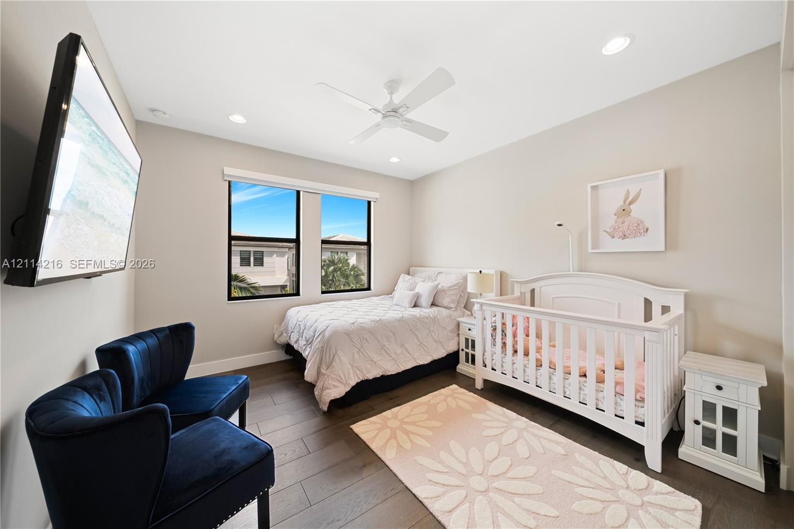 Neutral-toned room featuring wood-finish flooring, recessed lighting, and a ceiling fan