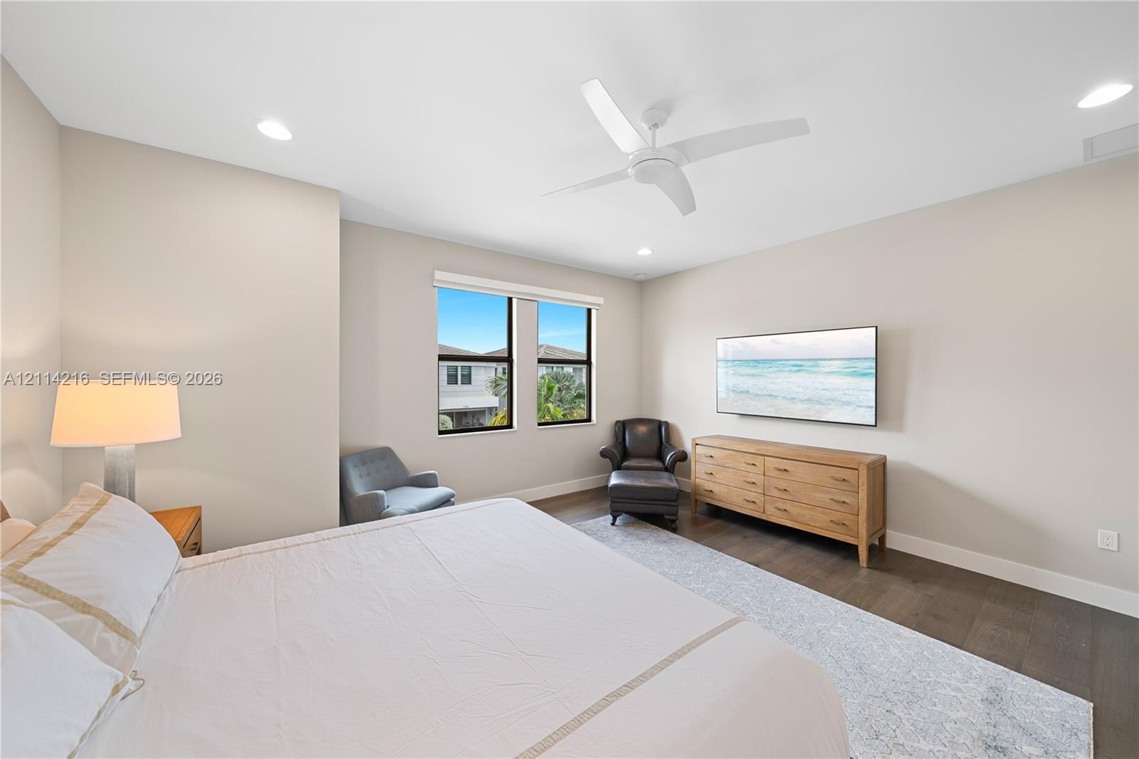 Neutral-toned interior featuring dark wood-finish flooring, recessed lighting, and a white ceiling fan