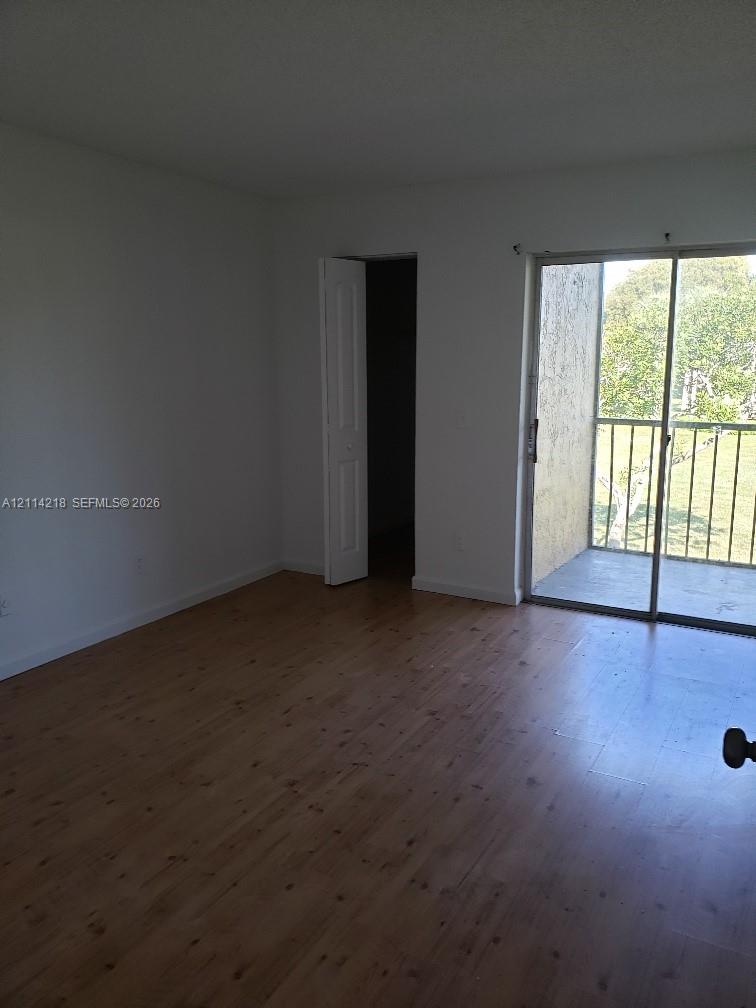 Wood-finish flooring, sliding glass door, and private exterior balcony
