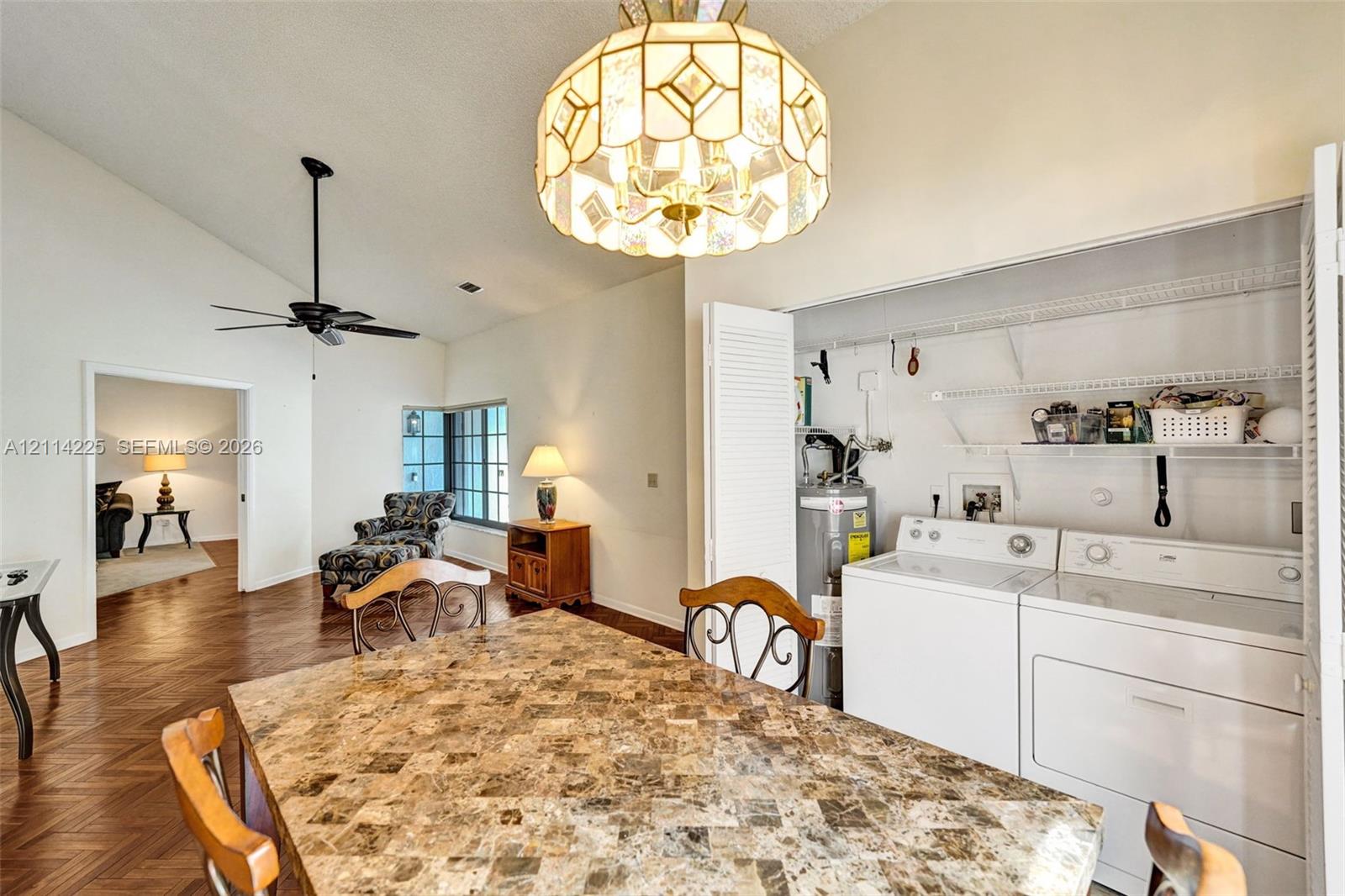 Vaulted ceilings, wood-finish herringbone flooring, and custom-designed stained glass multi-tier pendant lighting