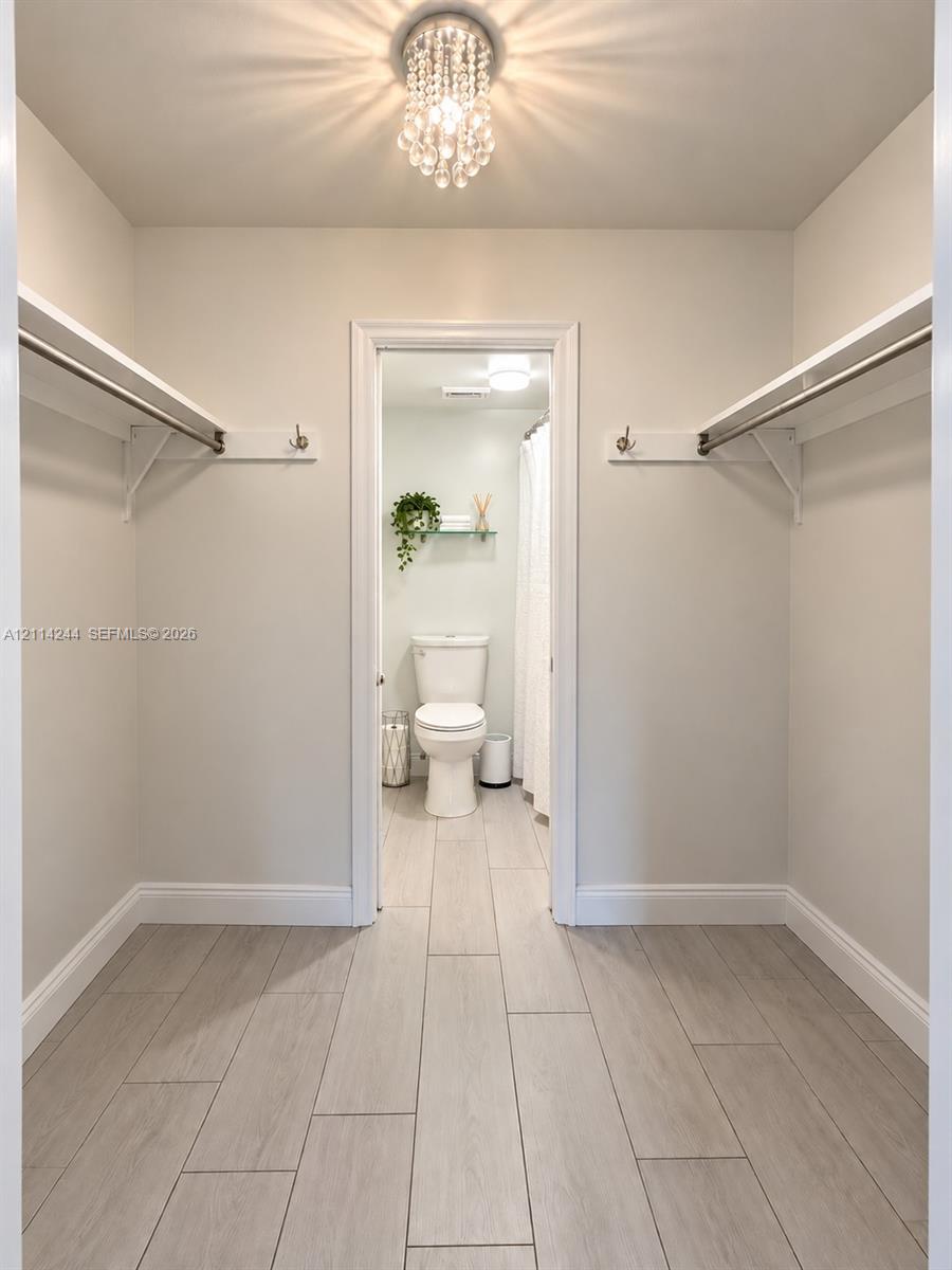 Walk-in closet from master bedroom to bathroom.