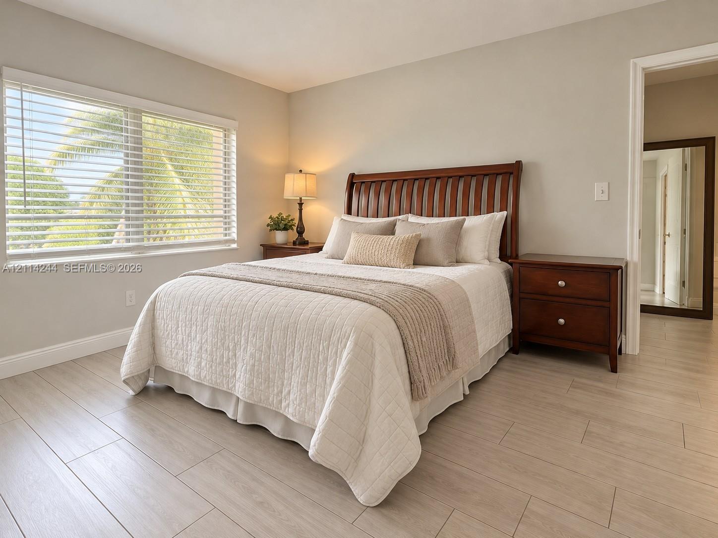 Master bedroom overlooking golf course garden view.