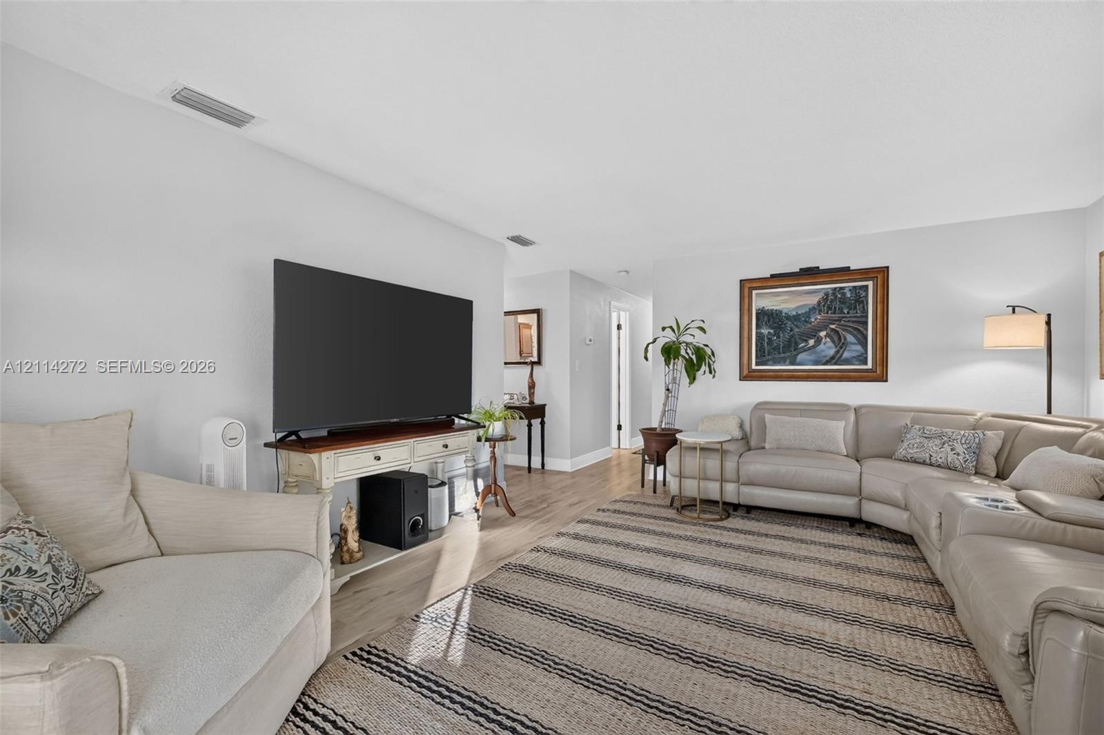Neutral-toned interior featuring wood-finish flooring and smooth-textured walls