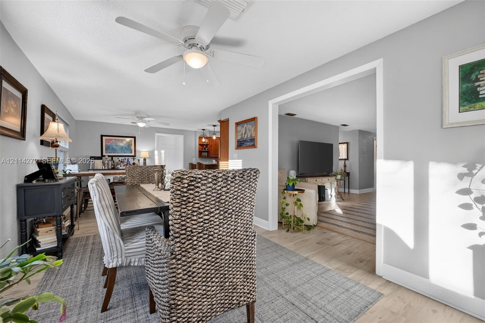 Neutral wall palette with wood-finish flooring and multiple ceiling fans