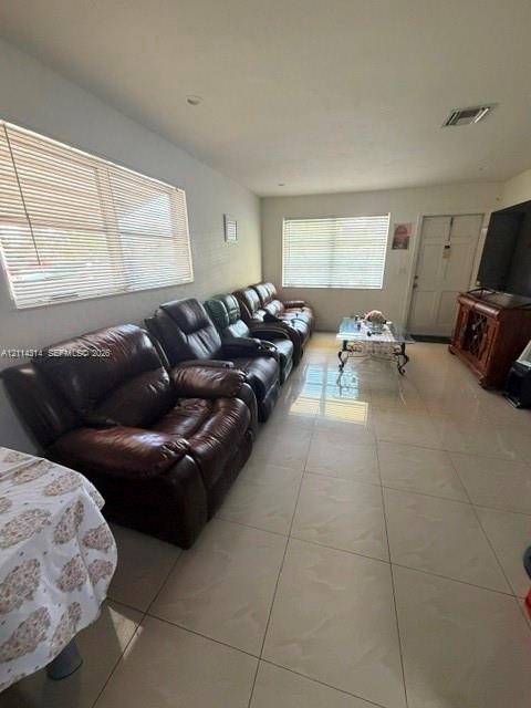 Large-format neutral tile flooring throughout with recessed lighting and multiple windows featuring horizontal blinds Large-format neutral tile flooring throughout with recessed lighting and multiple windows featuring horizontal blinds