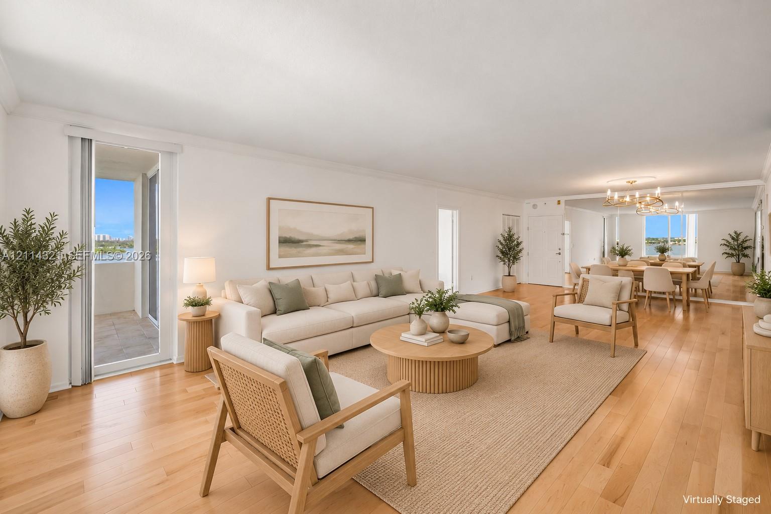 Open-concept living space featuring wood-finish flooring, recessed lighting, floor-to-ceiling mirrored wall paneling, and sliding glass door access to a private balcony