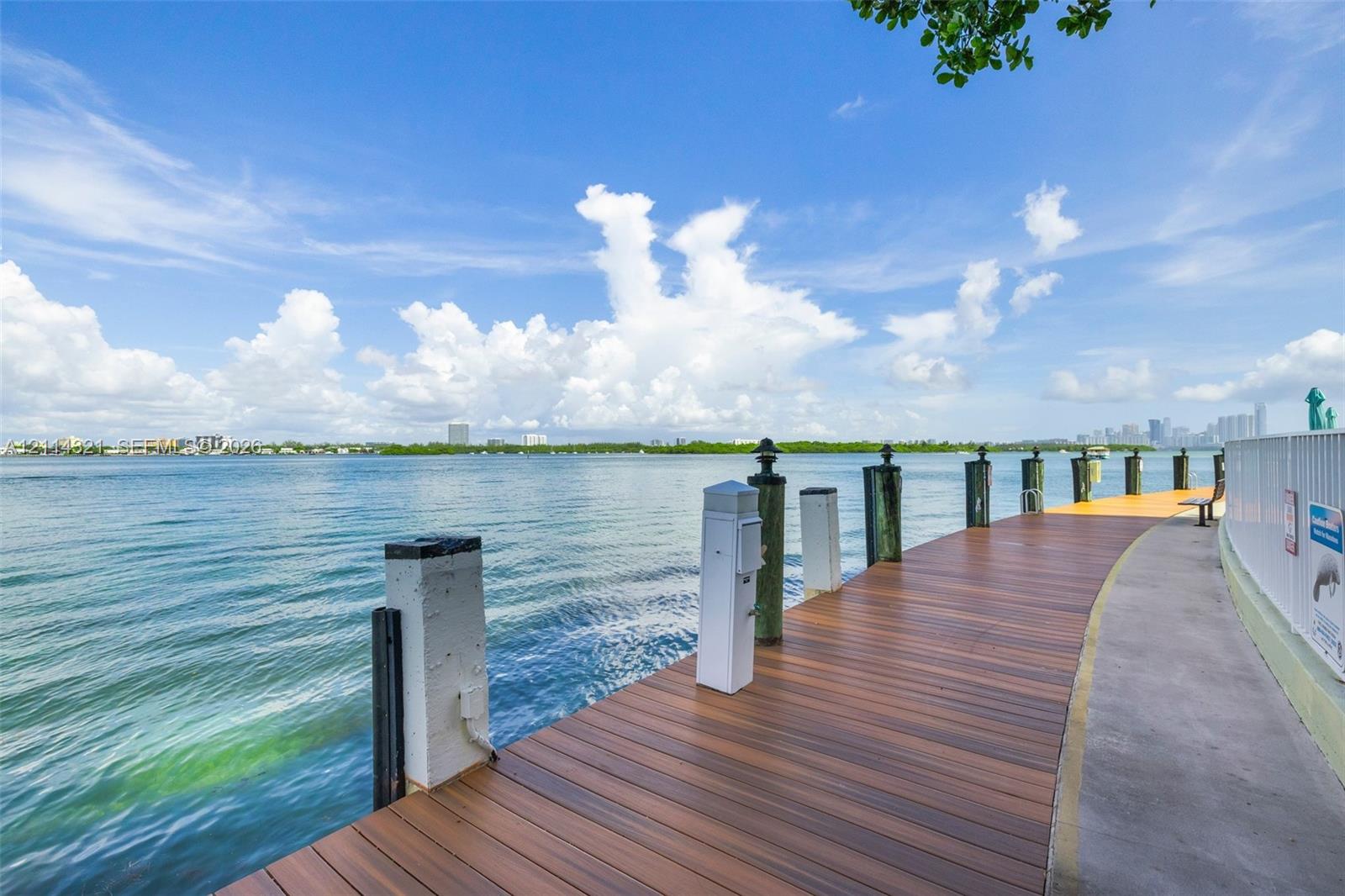 Waterfront wooden deck featuring built-in lighting and nautical pilings