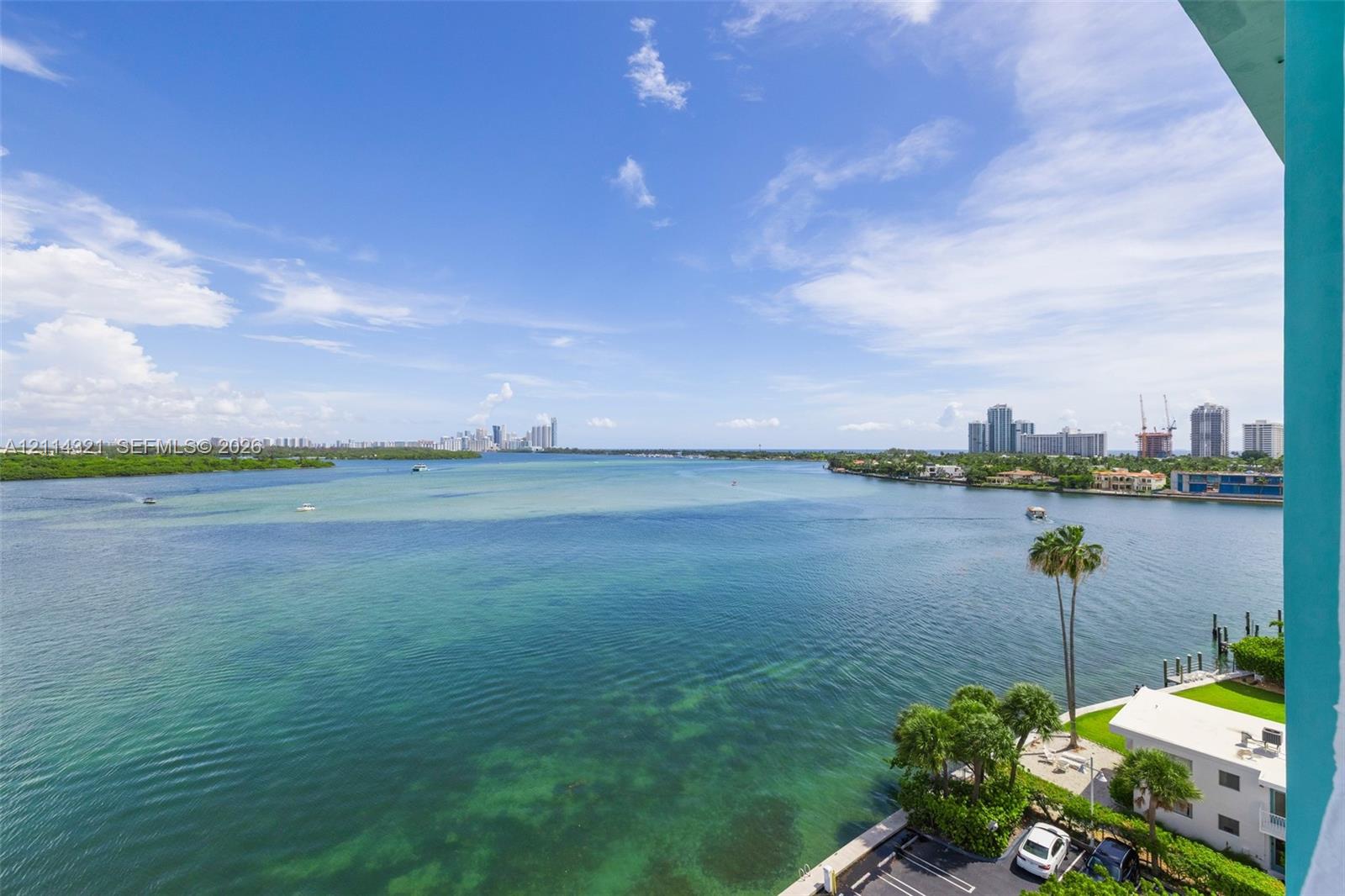 Elevated balcony featuring an expansive water panorama and coastal skyline
